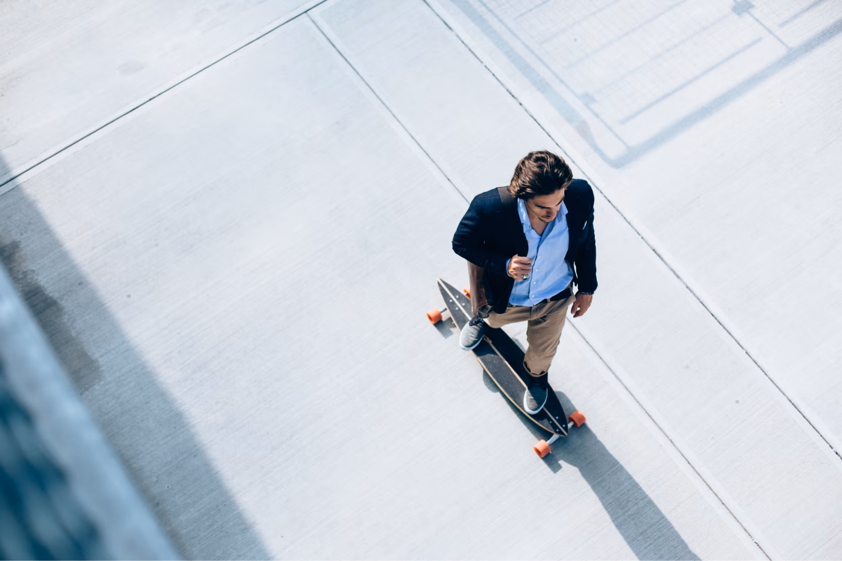 Man skating wearing a blaser